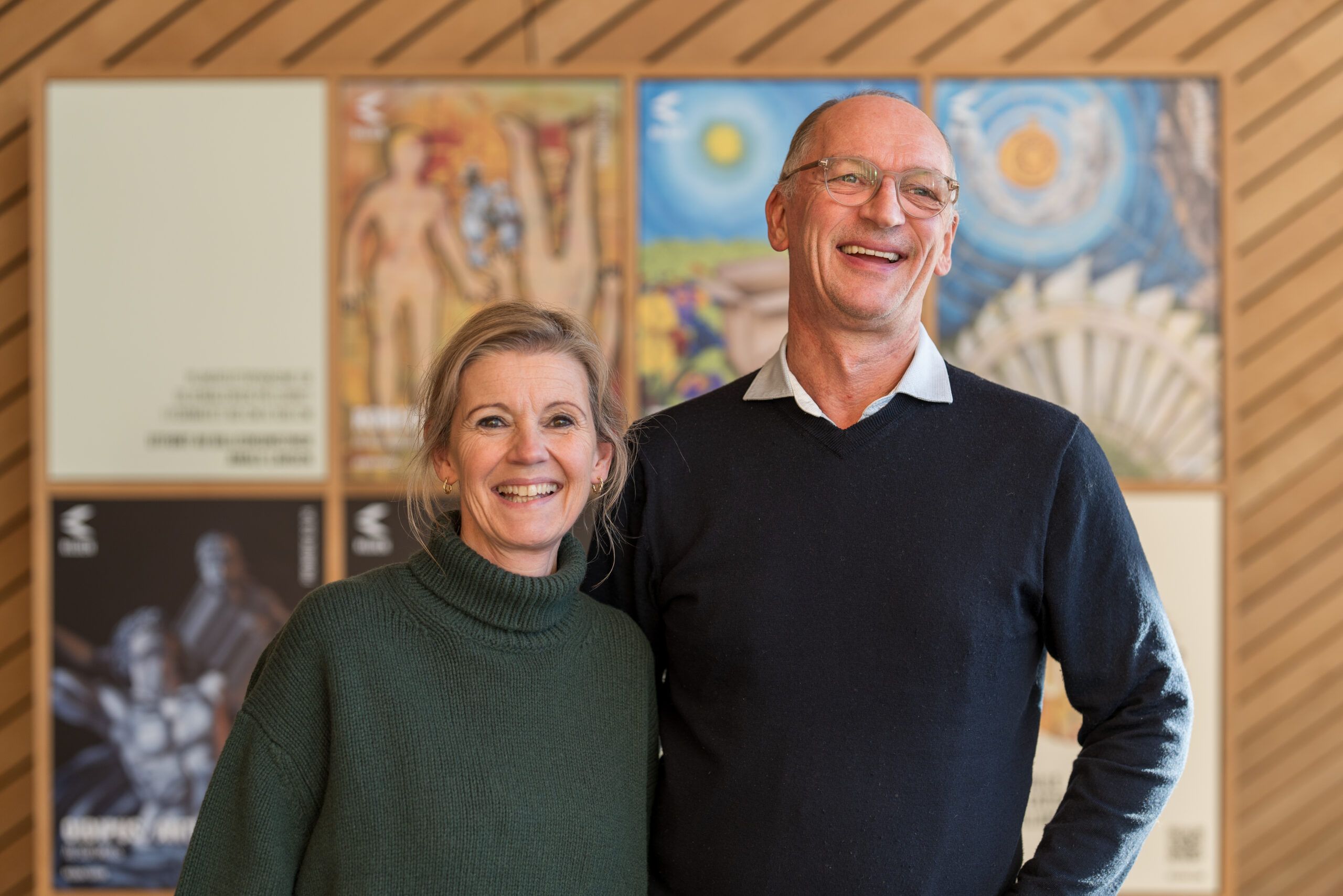 Teaterkortinnehavere Lene Hartveit og Laurits Hvidevoll foran Kilden Teaters plakatvegg.