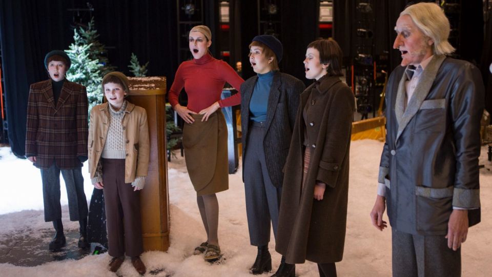 Bilde av seks skuespillere i kostymer som står på en scene.