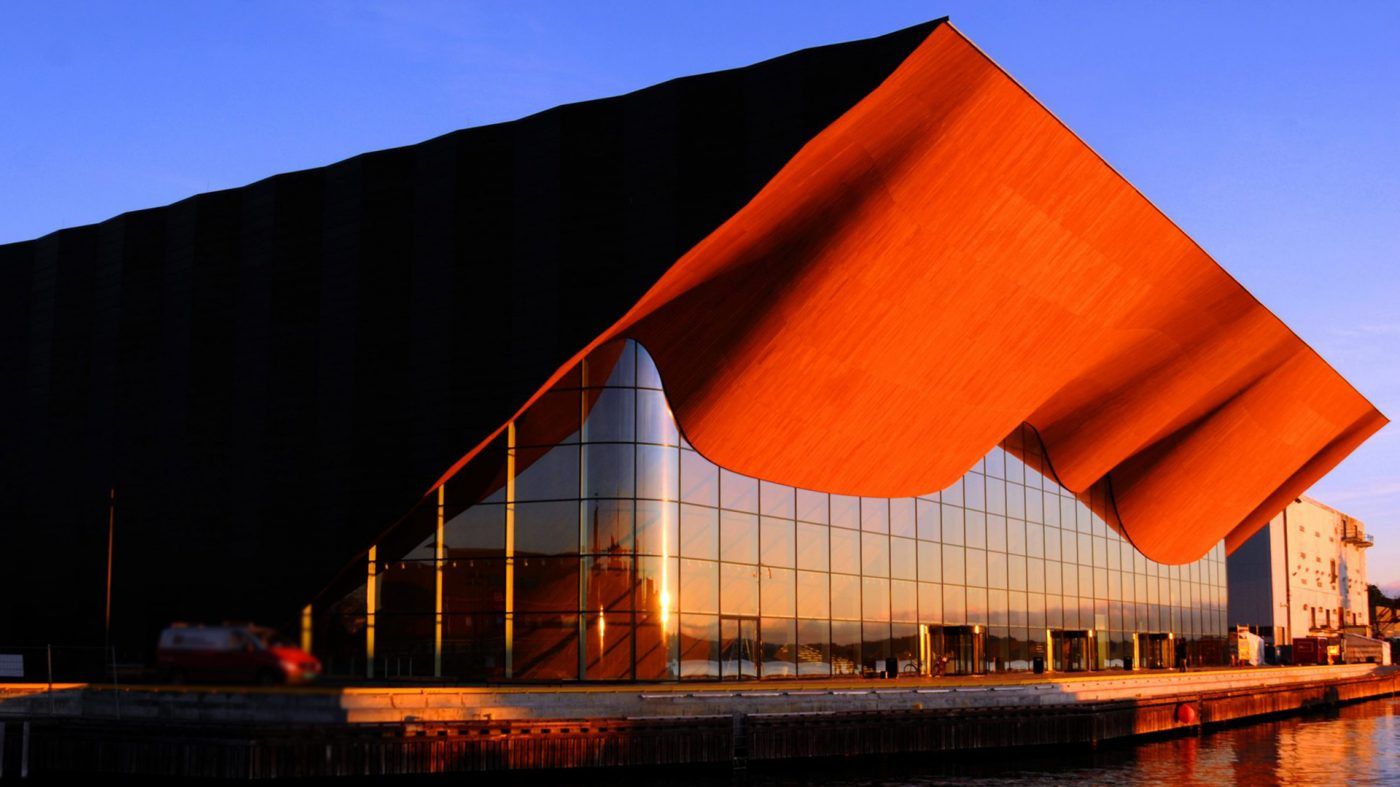 A photo of Kilden at sunset with a blue sky above.